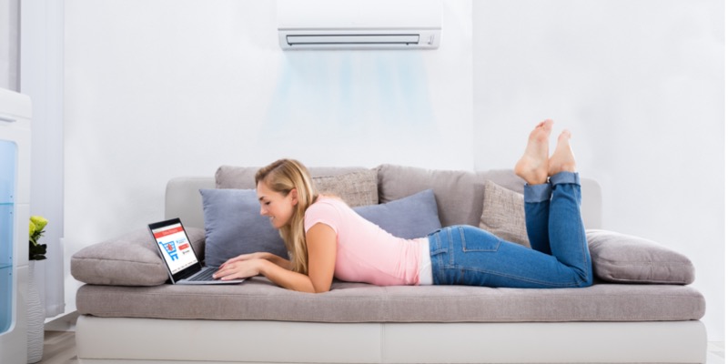 Woman relaxing with the AC on 
