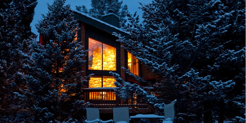 house with lights on in winter