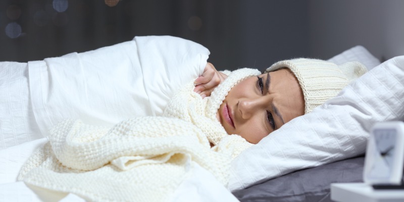 woman bundled up in bed