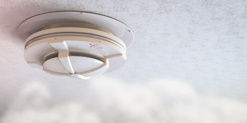 CO Alarm on ceiling with smoke around alarm - What do you do if a carbon monoxide alarm goes off?    